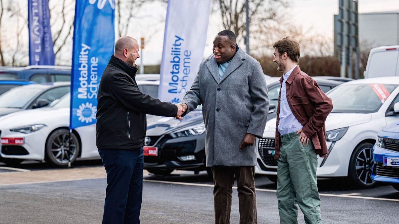 Handing over a new mobility scooter to a customer