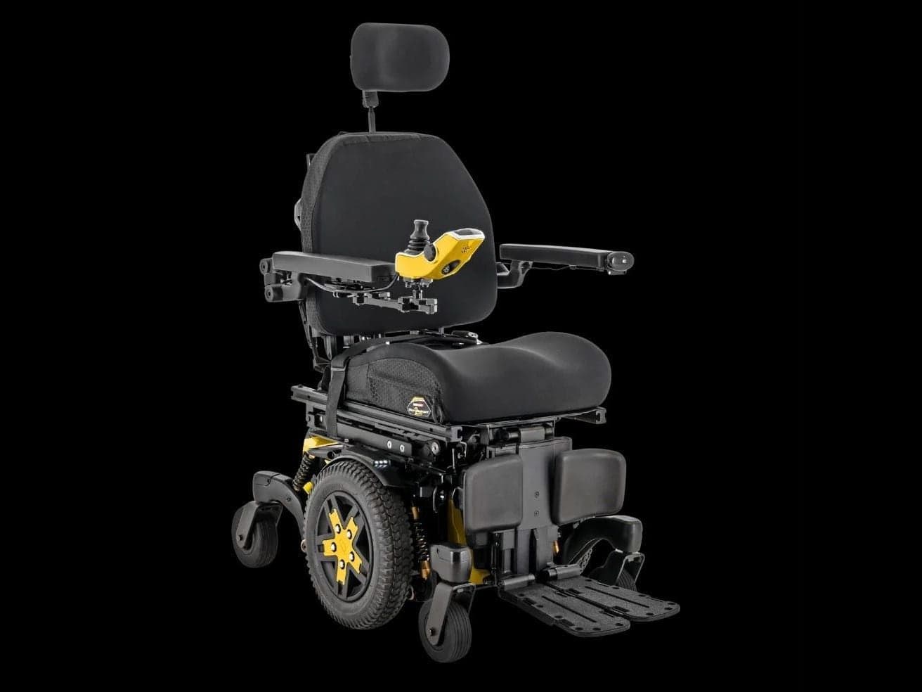Quantum Stretto powerchair in black with yellow wheel trims, a headrest and a joystick control