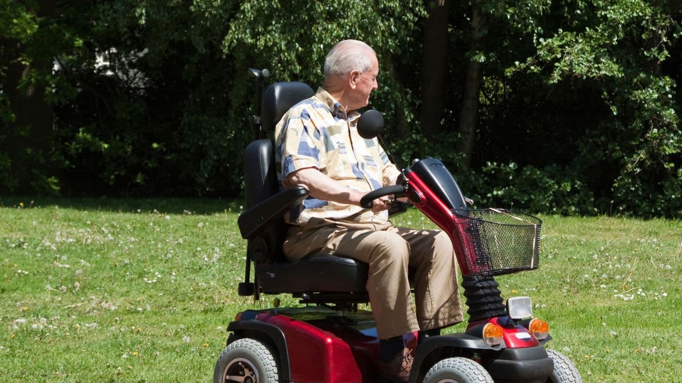 A mobility scooter parked on a lawn